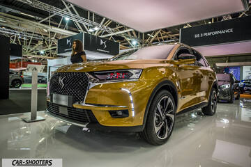 front three-quarter, gold at an indoor auto show