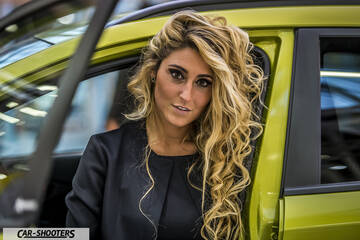 side profile, yellow-green with a model standing by