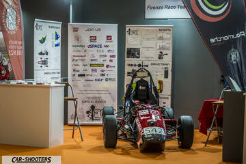front three-quarter, red at an indoor exhibition