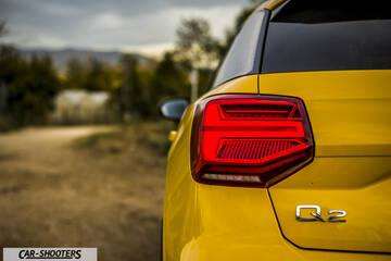 Audi Q2 – rear three-quarter, yellow on a country road