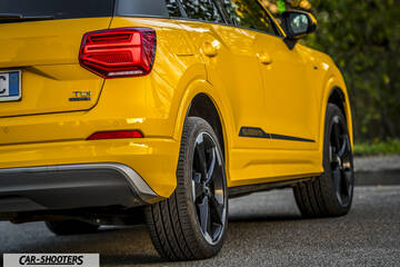 Audi Q2 – rear three-quarter, yellow on an asphalt road