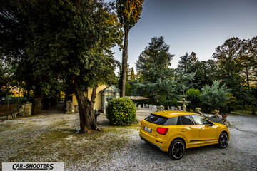 Audi Q2 – rear three-quarter, yellow in a park with trees