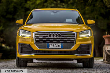 Audi Q2 – front three-quarter, yellow on a gravel driveway