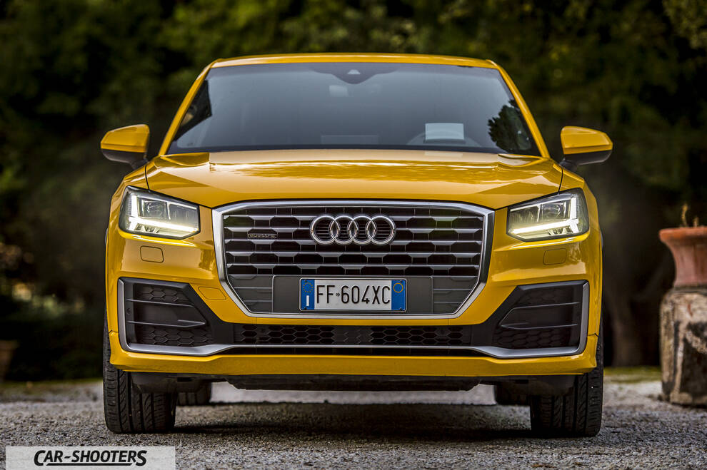 Audi Q2 – front three-quarter, yellow on a gravel driveway