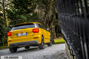 Audi Q2 – rear three-quarter, yellow on a gravel driveway