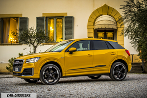Audi Q2 – side profile, yellow parked against a building
