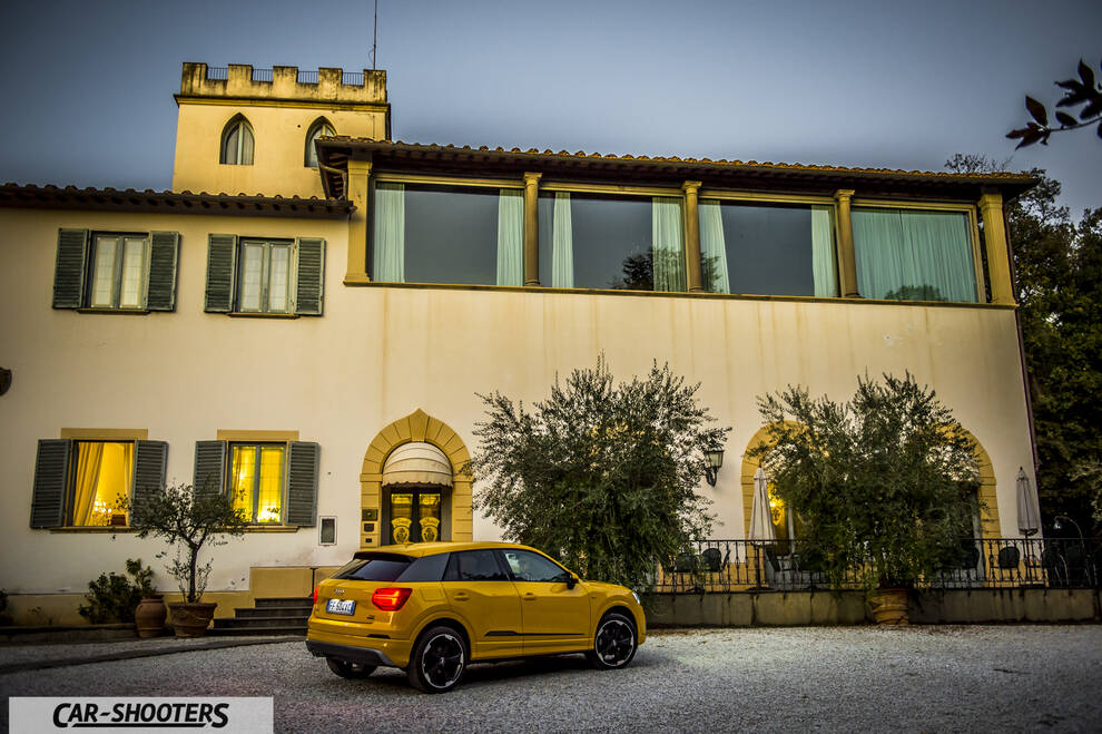 Audi Q2 – rear three-quarter, yellow against a historic building backdrop
