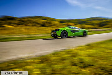 Mclaren 570S – rear three-quarter, bright green on a country road