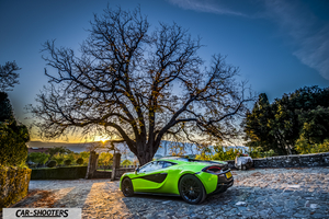 Mclaren 570S – rear three-quarter, bright green parked on a cobblestone courtyard