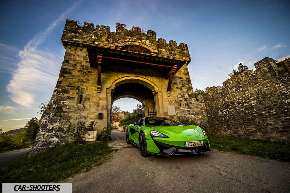 Mclaren 570S – front three-quarter, green against a stone castle backdrop