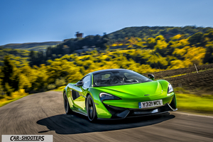 Mclaren 570S – front three-quarter, bright green on a country road