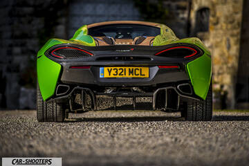 Mclaren 570S – rear view, green on a gravel surface