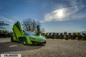 Mclaren 570S – front three-quarter, bright green on a gravel courtyard