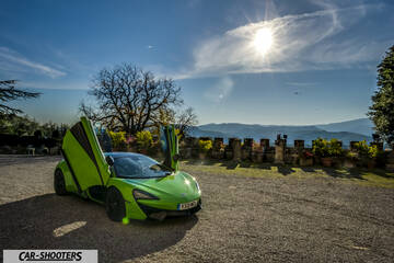 Mclaren 570S – front three-quarter, bright green against a mountain backdrop