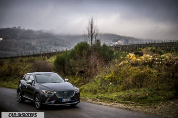Mazda CX 3 – front three-quarter, dark grey metallic on a country road