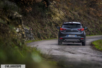Mazda CX 3 – rear view, dark grey metallic on a country road