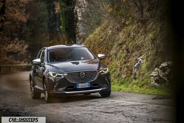 Mazda CX 3 – front three-quarter, dark grey metallic on a country road