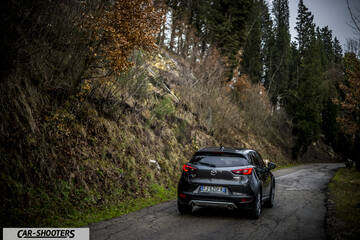 Mazda CX 3 – rear three-quarter, dark grey metallic on a country road