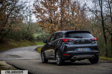 Mazda CX 3 – rear three-quarter, dark grey metallic on a country road