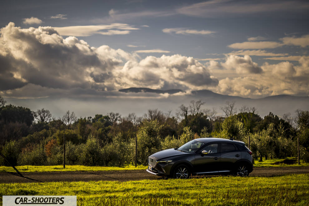 Mazda CX 3 – side profile, dark grey against a mountain backdrop