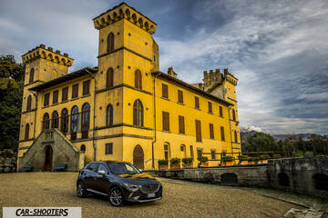 Mazda CX 3 – front three-quarter, dark grey metallic against a historic castle backdrop