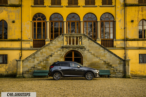 Mazda CX 3 – side profile, grey metallic against a yellow building