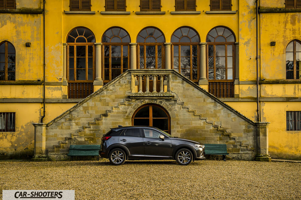 Mazda CX 3 – side profile, grey metallic against a yellow building