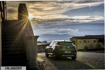 Mazda CX 3 – rear three-quarter, dark green parked near old buildings at sunset