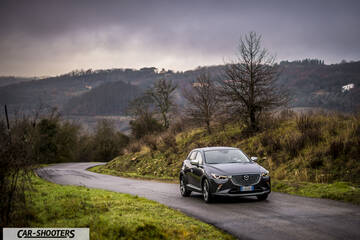 Mazda CX 3 – front three-quarter, dark grey on a winding country road