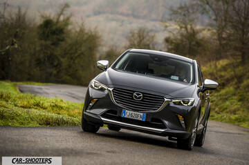 Mazda CX 3 – front three-quarter, dark grey metallic on a country road