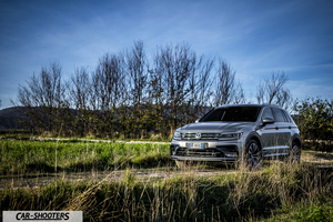 Volkswagen Tiguan – front three-quarter, silver metallic on a rural dirt road