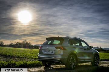 Volkswagen Tiguan – rear three-quarter, silver on a rural road at sunset
