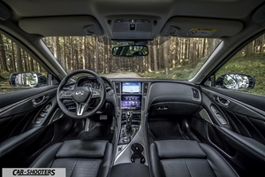 Infiniti Q50 – dashboard, facing a forest road