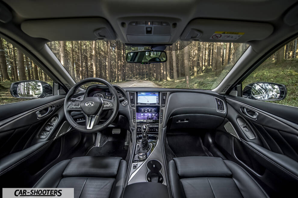 Infiniti Q50 – dashboard, facing a forest road