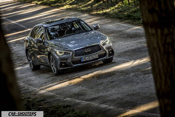 Infiniti Q50 – front three-quarter, grey metallic on a country road