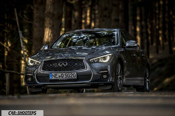 Infiniti Q50 – front three-quarter, grey metallic on a country road
