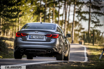 Infiniti Q50 – rear view, grey metallic on a country road