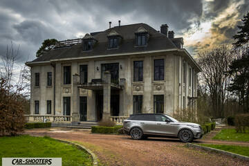 side profile, silver in front of a large mansion