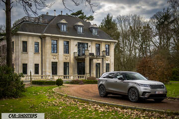 front three-quarter, silver metallic in front of a mansion