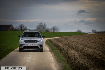 front three-quarter, silver metallic on a country road