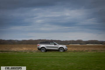 side profile, silver driving across a grassy field