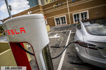 Tesla Model S – rear three-quarter, silver at a charging station
