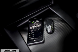 Tesla Model S – detail, smartphone and key fob on console