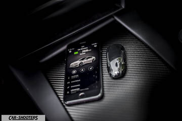 Tesla Model S – detail, smartphone and key fob on console