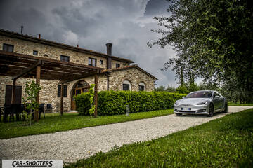 Tesla Model S – front three-quarter, silver on a gravel driveway