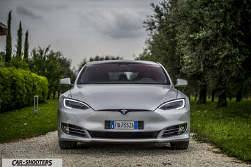 Tesla Model S – front three-quarter, silver on a gravel driveway