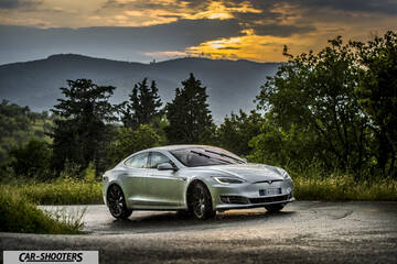 Tesla Model S – front three-quarter, silver metallic against a mountain backdrop