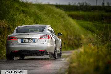 Tesla Model S – rear three-quarter, silver on a country road