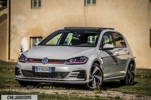 Volkswagen Golf GTI – front three-quarter, silver parked on grass