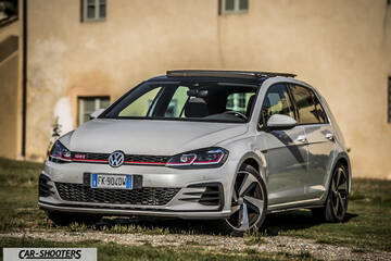 Volkswagen Golf GTI – front three-quarter, silver parked on grass